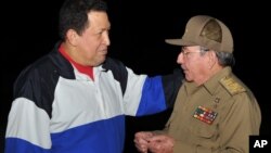 In this picture released Tuesday, Dec. 11, 2012 by Cuba's state newspaper Granma, Cuba's President Raul Castro, right, receives Venezuela's President Hugo Chavez at the Jose Marti International Airport in Havana, Cuba on Dec. 10, 2012. 