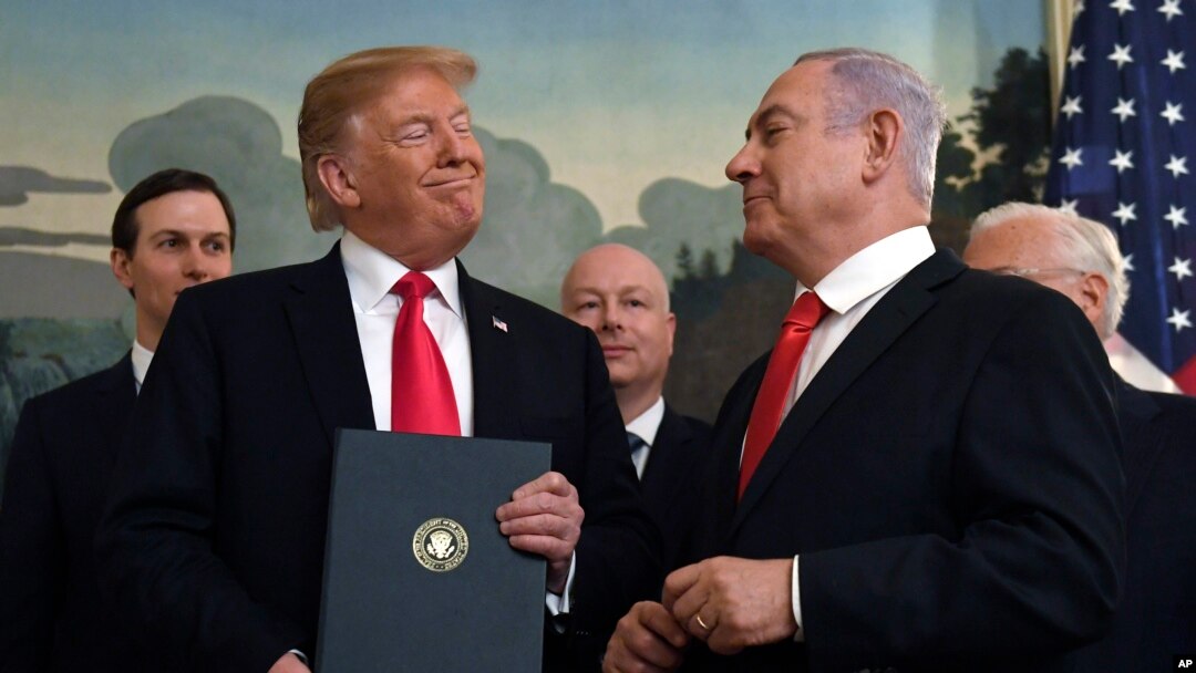 FILE - In this March 25, 2019 file photo, President Donald Trump smiles at Israeli Prime Minister Benjamin Netanyahu, right, after signing a proclamation at the White House in Washington.