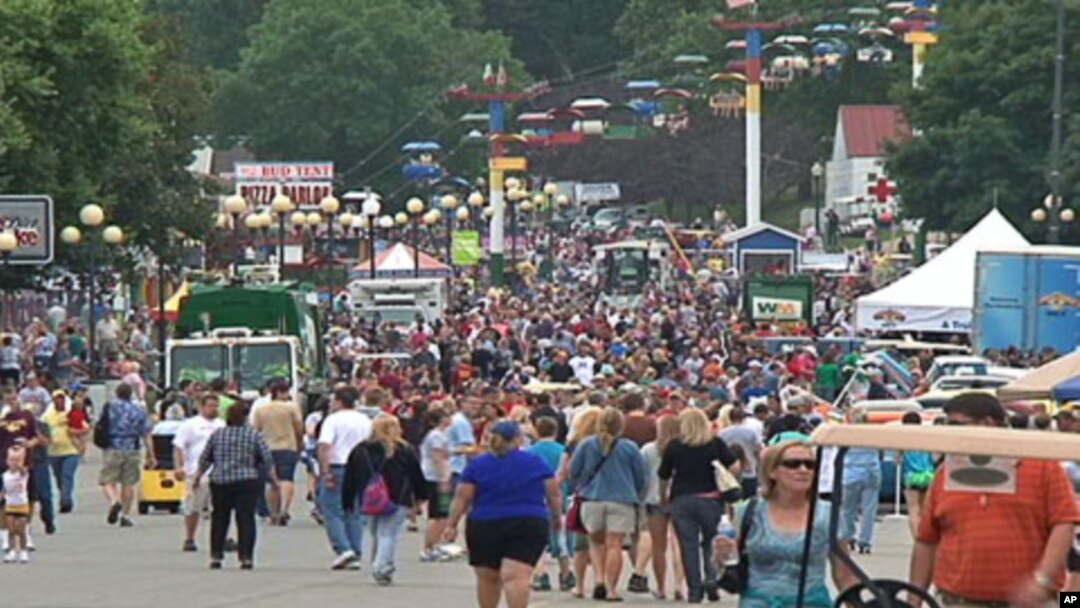A crowd walks along part of the fair grounds at the Iowa State Fair, in the state capital Des Moines, August 12, 2011