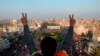 A protester flashes the victory sign while anti-government protesters gather in Tahrir Square during ongoing protests in Baghdad, Iraq, Oct. 31, 2019. 