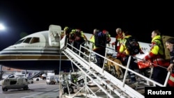 FILE —Rescuers of International Search and Rescue (ISAR) Germany board a charter plane, on their way to help find survivors of the deadly earthquake in Turkey, at Cologne-Bonn airport, Germany, February 7, 2023.