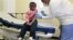 Four-year-old Gabriella Diaz sits as registered nurse Charlene Luxcin (R) administers a flu shot at the Whittier Street Health Center in Boston, Massachusetts, January 9, 2013. Boston declared a public health emergency and the state reported 18 flu-relate
