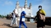 FILE - Health workers arrive to administer cervical cancer vaccine HPV Gardasil to young girls on the street in Ibadan, Nigeria, May 27, 2024. The World Health Organization estimates that 80% of childhood cancers occur in low-income countries like Nigeria,