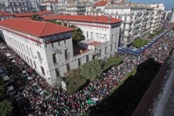 FILE - Algerians take to the streets in the capital Algiers to protest against the government, in Algeria, Nov. 1, 2019.