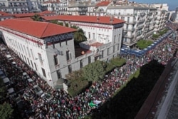 Algerian demonstrators take to the streets in the capital Algiers to protest against the government, in Algeria, Nov. 1, 2019. Police struggled Friday to contain thousands of Algerian demonstrators protesting next month's presidential election.