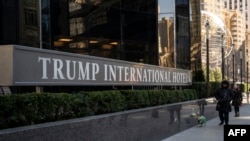 La gente camina junto a una de las propiedades que le podrían ser embargadas al expresidente Donald Trump, el Trump International Hotel, en Nueva York, EEUU, el 21 de marzo de 2024.