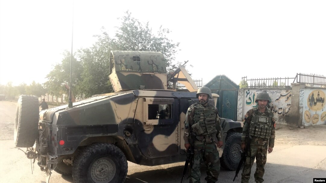 Afghan soldiers stand guard near the site of a blast in Kabul, Afghanistan, July 15, 2018. 