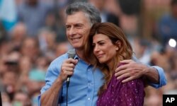 FILE - Argentina's President Mauricio Macri and his wife, Juliana Awada, react during a rally in support of Macri, in Buenos Aires, Argentina, Dec. 7, 2019. He lost to opposition candidate Alberto Fernandez.