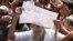 An elderly Rohingya refugee holds a placard during a protest against the repatriation process at Unchiprang refugee camp near Cox's Bazar, in Bangladesh, Nov. 15, 2018. 