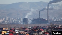 FILE - Smoke billows from the chimneys of a coal-burning power plant in Ulan Bator October 14, 2011. Researchers has announced a successful experiment that turned carbon dioxide into useful liquid fuel. 
