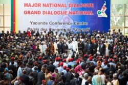 FILE - People gather at the Congress Palace during the opening session of the National Dialogue called by President Paul Biya, in Yaounde, Cameroon, Sept. 30, 2019.