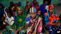 FILE - Peul women sit in a house across the Nour Islam mosque where they found refuge in Bangui, Central African Republic, Dec. 11, 2013.