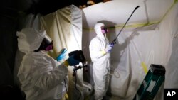 Asbestos Removal Technologies Inc. technicians are seen performing asbestos abatement in Howell, Michigan, Oct. 18, 2017.