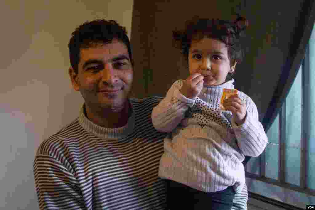 Ahmad with his daughter Ritaj, 2. Ahmad fears that his children will not get an education, John Owens/VOA.