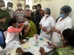 FILE - A health worker administers a dose of the Covishied vaccine for COVID-19 at Railway hospital in Prayagraj, India. Saturday, June 26, 2021. (AP Photo/Rajesh Kumar Singh)