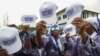 Supporters of the leader of Liberia's ruling party Coalition for Democratic Change , President and former soccer player George Weah, holds their caps as they attend to his final campaign rally for the presidential elections in Monrovia, Liberia October 8, 2023. 