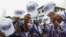 Supporters of the leader of Liberia's ruling party Coalition for Democratic Change , President and former soccer player George Weah, holds their caps as they attend to his final campaign rally for the presidential elections in Monrovia, Liberia October 8, 2023. 