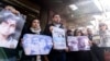 Activists and relatives take part in a protest demanding the whereabouts of four activists who disappeared during the war between opposition groups and former President Bashar al-Assad's forces, in Douma, Syria, Jan. 1, 2025.