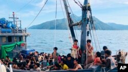 In this handout photo released on April 5, 2020 by the Malaysian Maritime Enforcement Agency, a wooden boat carries suspected Rohingya migrants detained in Malaysian territorial waters off the island of Langkawi.