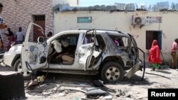 The vehicle wreckage of Somalia's government spokesperson Mohamed Ibrahim Moalimuu is seen at the scene of an explosion Mogadishu, Jan. 16, 2022.
