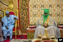 FILE — Atiku Abubakar, Presidential candidate of the People's Democratic party, left, visits the Emir of Kano Aminu Ado Bayero, right, at his palace before an election campaign in Kano, Nigeria February 9, 2023