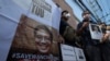 Activists hold photos of Thai dissident Wanchalearm Satsaksit gather for a rally in front of Cambodian Embassy in Bangkok, Thailand, June 8, 2020. 