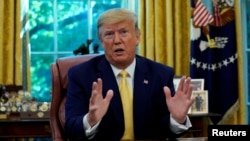 FILE - U.S. President Donald Trump speaks during a meeting in the Oval Office at the White House, Oct. 11, 2019. 