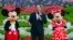 Joe Schott, center, president and general manager of Shanghai Disney Resort, speaks, along with Mickey and Minnie Mouse, during its reopening ceremony after the coronavirus closure in Shanghai, China, May 11, 2020. 