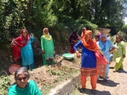Women in Tanda village on the Himalayan slopes in Himachal Pradesh are among the millions of poor women who get 100 days of work a year as part of India's rural employment welfare scheme for poor rural households. (A. Pasricha/VOA)