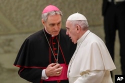 FILE—Pope Francis talks with Papal Household Archbishop Georg Gaenswein during his weekly general audience, in Paul VI Hall at the Vatican, on January 15, 2020.