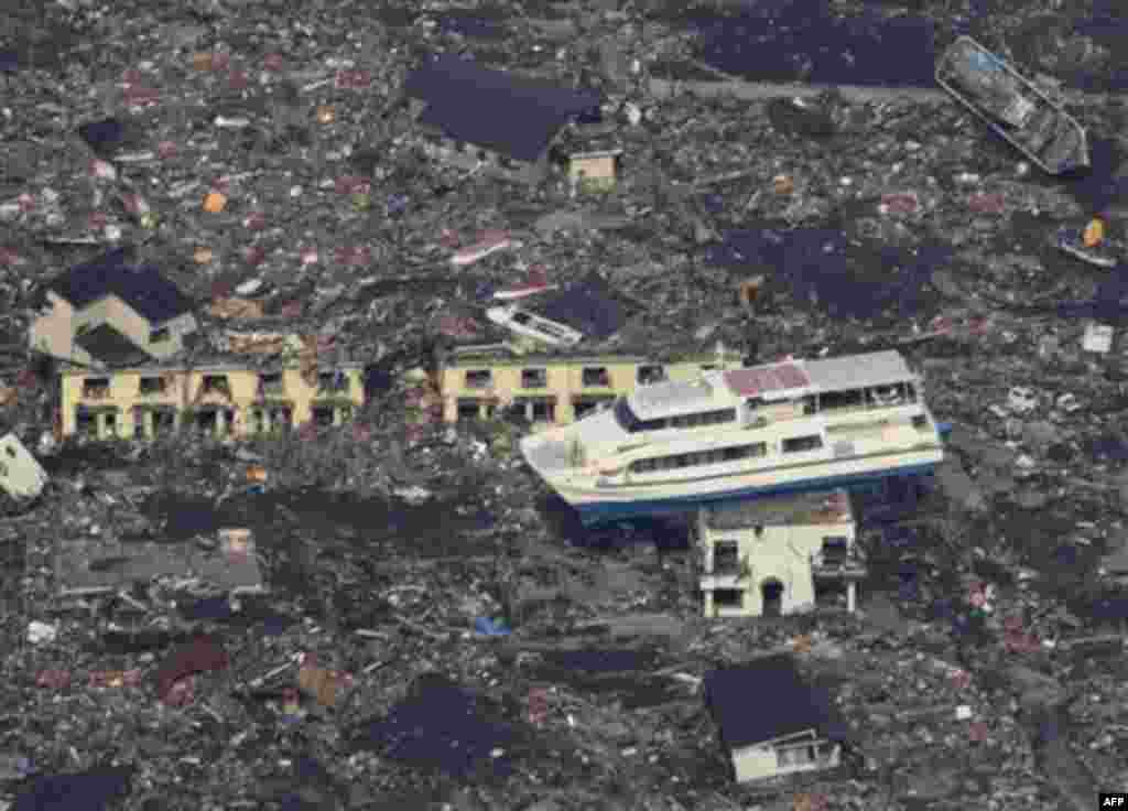 A ferry stranded on a building is seen in Otsuchi, Iwate Prefecture, northern Japan, Sunday, March 13, 2011, two days after a powerful earthquake-triggered tsunami hit the country's east coast. (AP Photo/The Yomiuri Shimbun) JAPAN OUT, CREDIT MANDATORY