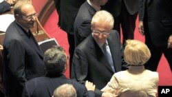 Former European Commissioner Mario Monti (2nd R) is greeted by senators as he arrives at the Senate in Rome November 11, 2011.