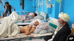 Men lie on beds at a hospital after they were wounded in the deadly attacks outside the airport in Kabul, Afghanistan, Aug. 27, 2021. This, as medical supplies in the country are almost exhausted.