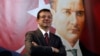 Backdropped by a poster of modern Turkey's founder, Mustafa Kemal Ataturk, Ekrem Imamoglu, the Republican People's Party's mayoral candidate in Istanbul, poses following an interview in Istanbul, April 4, 2019. 