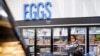 FILE - A woman buys eggs at a Walmart Superstore in Secaucus, New Jersey, July 11, 2024.