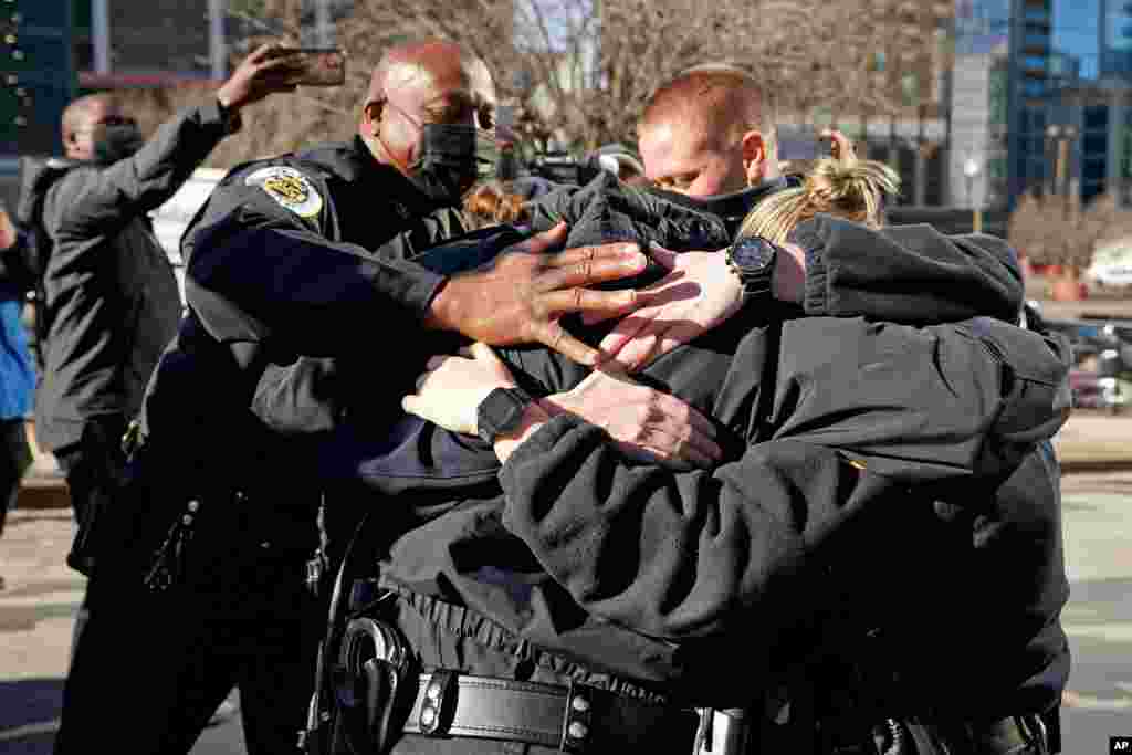 Nashville Police Chief John Drake, left, and a group of police officers embrace after speaking at a news conference, Dec. 27, 2020, in Nashville, Tennessee.&#160;The officers are credited with evacuating people before an explosion in downtown Nashville.