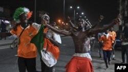 Ivorian fans celebrate in the streets of Abidjan after their team defeated Senegal during the 2023 Africa Cup of Nations match, January 29, 2024.