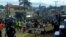 FILE - Hundreds of youths run through the streets of Ekona, cheering, waving palm fronds, and holding signs demanding independence in this image taken from video, Sept. 22, 2017. 