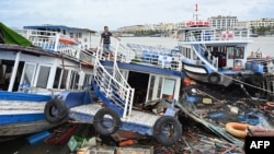 A man checks his damaged boat after Super Typhoon Yagi hit Ha Long bay, in Quang Ninh province, Vietnam, on Sept. 8, 2024.