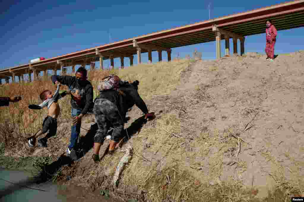 Migrants cross the Rio Bravo river to turn themselves in to U.S Border Patrol agents to request for asylum in El Paso, Texas, as seen from Ciudad Juarez, Mexico, Feb. 8, 2021.