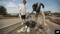 Volunteers participating in the International Coastal Cleanup collect litter in the Anacostia area of Washington, DC.