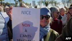 FILE — A protester holds a placard reading "Nice says no to anti-Semitism" during a demonstration in the French Riviera city of Nice, southern France, on November 12, 2023.