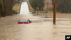 This photo provided by the Warren County, Ky., Sheriff's Office shows a partially submerged car outside of Bowling Green, Ky., on Feb. 15, 2025. 