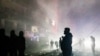 People stand surrounded by smoke at the site of an Israeli airstrike that targeted a neighbourhood in Tyre, southern Lebanon, on November 25, 2024, amid the ongoing war between Israel and Hezbollah.