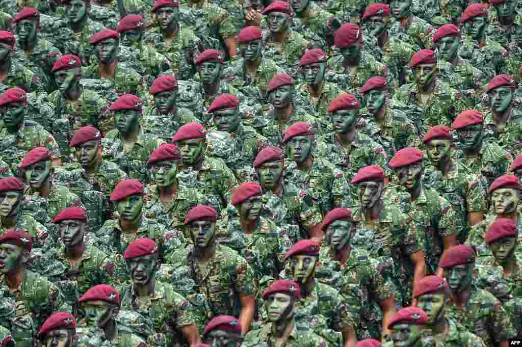 Members of Malaysia&#39;s military parade past during National Day celebrations at Independence Square in Kuala Lumpur.