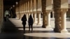 FILE- Students walk on the Stanford University campus in Santa Clara, California, March 14, 2019. 