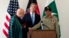 FILE - U.S. Secretary of State John Kerry (C) laughs as Afghan President Hamid Karzai and Pakistani Army Chief General Ashfaq Parvez Kayani shake hands after he made a statement following a meeting in Brussels, April 24, 2013. 