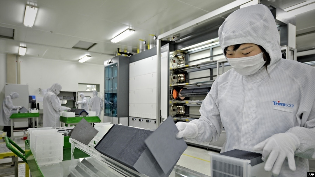 FILE - A worker sorts silicon wafers at the manufacturing center of solar cell maker Trina Solar in Changzhou, China. Trina now has a facility in the Hofusan Industrial Park, about 20 km north of Monterrey, Mexico, not far from the border with Texas.