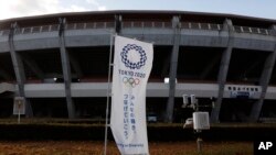 A Tokyo 2020 banner stands in front of the Azuma Baseball Stadium, a venue for baseball and softball at the Tokyo 2020 Olympics, Saturday, Nov. 30, 2019, in Fukushima, Fukushima prefecture, Japan.