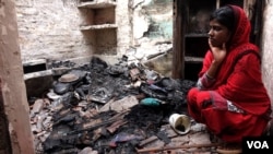 Hena Tabassum, 20, at her house in Telinipara, two days after it was attacked by Hindus. The attackers threw Molotov cocktails to set it on fire and used a gas cylinder to trigger a big explosion. (Shaikh Azizur Rahman/VOA)